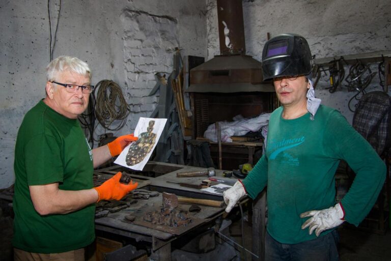 The Art of MFF | The sculpted fragments of the mask were carefully positioned on a bed of sand, then joined using electric welding. Sergey Melnikoff (left) and Viktor Bielchyk pictured in their Odesa workshop, 2024.