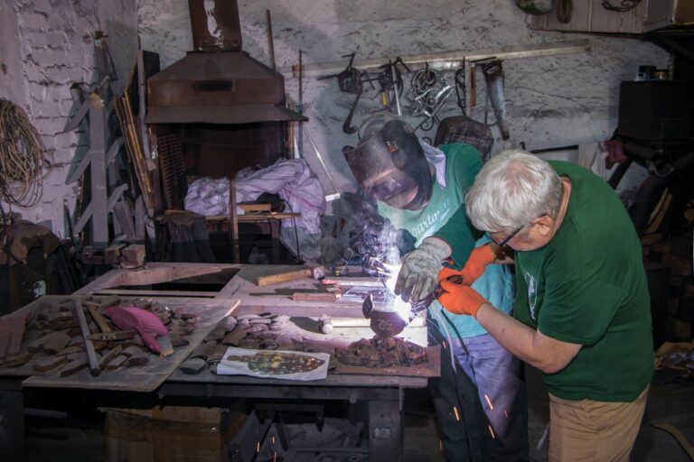 The Art of MFF | The carved elements of the mask were arranged on a mound of sand, where they were fused together using electric welding. Sergey Melnikoff (right) and Viktor Bielchyk in the workshop. Odesa, 2024