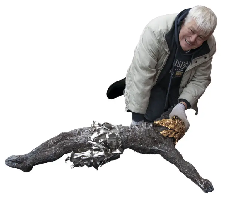 Sergey Melnikoff presents the assembled sculpture of the crucified Christ before it is sent for gilding using the electroplating method. The life-sized figure, roughly the height of a short adult, was crafted from 20,000 fragments of artillery shells and mines, with a total weight of approximately 20 kilograms.