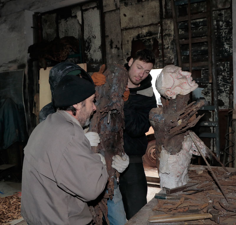 The Art of MFF | Viktor Belchik and two assistants install a 120-kilogram wing into the shoulder mounting bracket of the sculpture The Silent Uprising of an Angel.