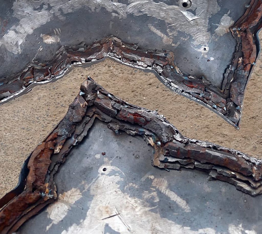 Fragments of the completed outer frame assembly — three layers built up and framed by precisely selected ribbon-shaped fragments.