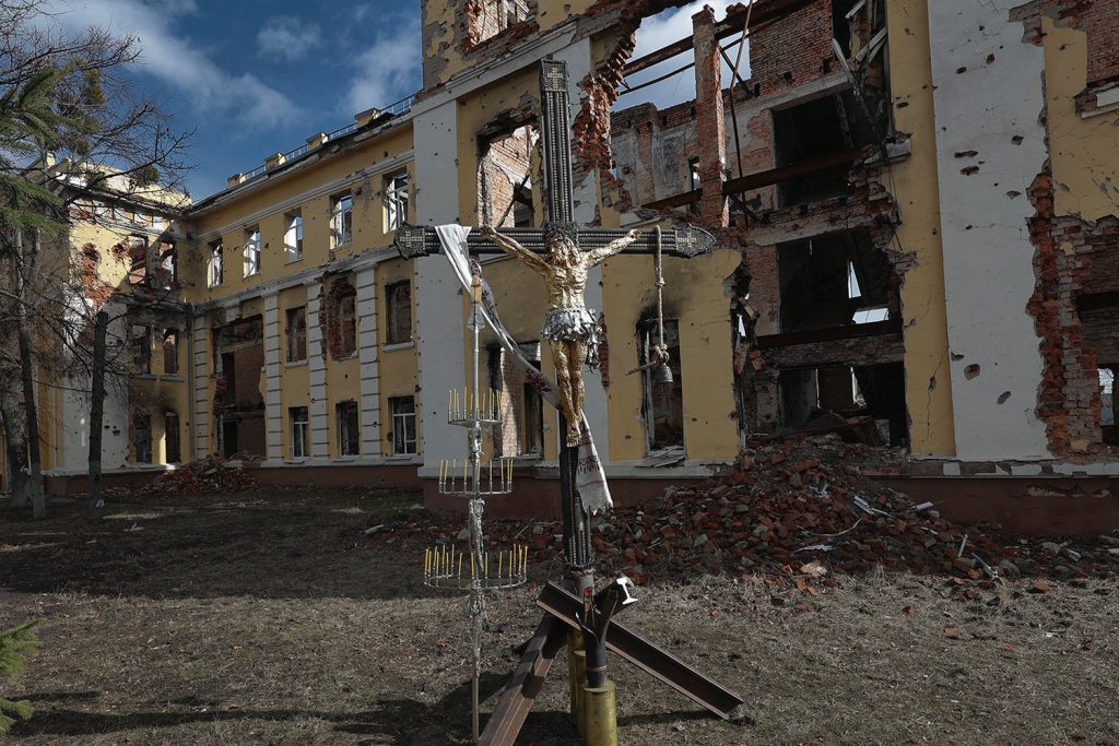 Installation of "The Cross of Peace" by Sergey Melnikoff (MFF) in Kharkiv in front of a destroyed gymnasium. Photograph: Vyacheslav Madiyevskyy / Ukrinform