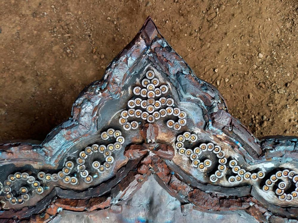 Decorative elements between the two frames, formed from fragments of 5.45 mm calibre cartridges — more than 700 are required.